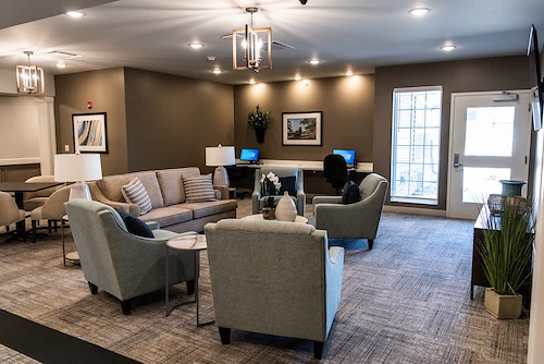 Inviting sitting area at Charter Senior Living of Hopkinsville in Hopkinsville, KY, featuring cozy furniture, warm lighting, and a computer station—designed for comfort and engagement in assisted living and memory care.