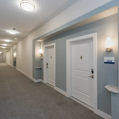 Acclaim at Cary Pointe, senior living community offering active adult and independent living in Cary, NC, well-lit hallway to apartments